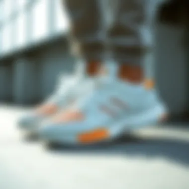Adidas shoes showcasing the white and orange color combination