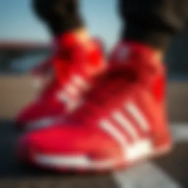 Close-up of Adidas red sneakers showcasing technical features