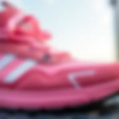 Close-up of Adidas Tensaur pink shoe detailing