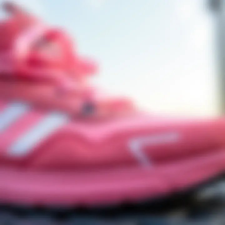 Close-up of Adidas Tensaur pink shoe detailing